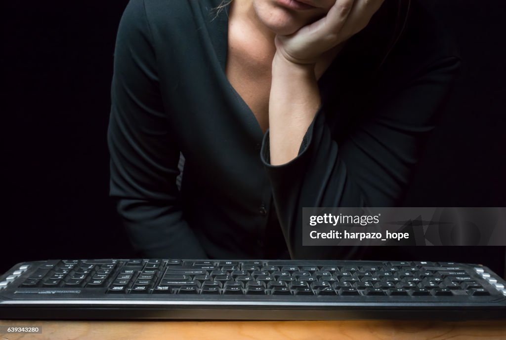 Woman in front of a keyboard.