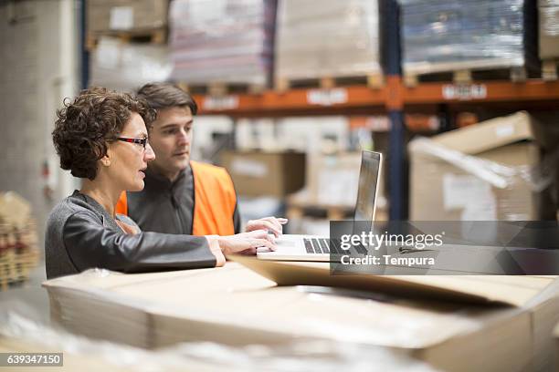 working hard. wearhouse workers. - business checklist stock pictures, royalty-free photos & images