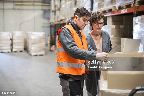 working hard. wearhouse workers. - wearhouse stock pictures, royalty-free photos & images