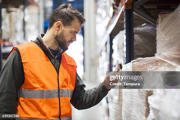 working hard. wearhouse workers. - wearhouse stock pictures, royalty-free photos & images