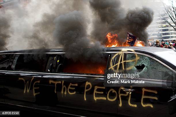 Limousine is set aflame with the graffiti of "We the People" spray painted on the side after the inauguration of Donald Trump as the 45th President...