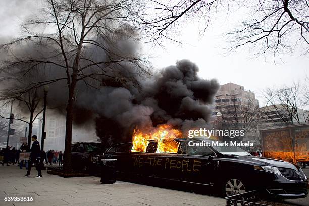 Limousine is set aflame with the graffiti of "We the People" spray painted on the side after the inauguration of Donald Trump as the 45th President...