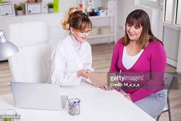overweight women at  nutritionist's office - nutritionist stock pictures, royalty-free photos & images