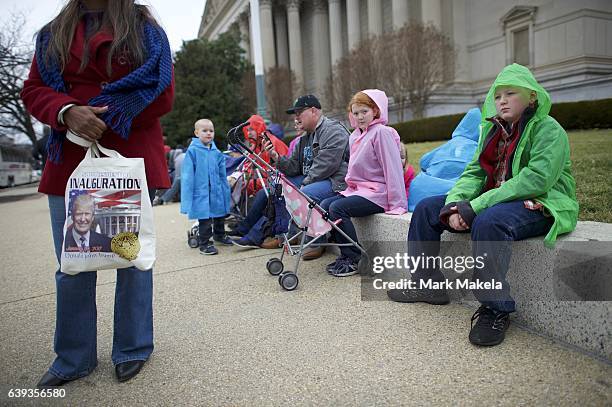 The Johnson family, comprising 10 children, aged 1-15, and their parents from Tucson, AZ, sit on a wall after the inauguration of Donald Trump as the...