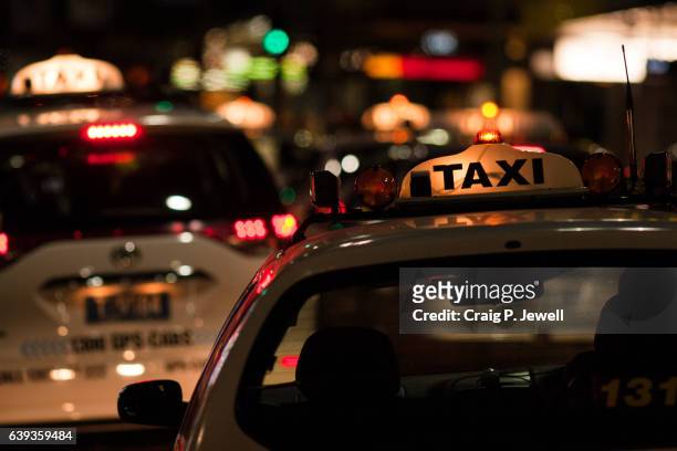 busy night in the city - australia taxi stock pictures, royalty-free photos & images