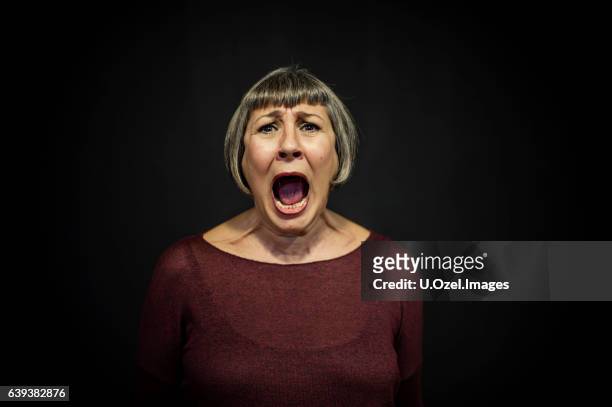 senior man portrait on black background - screaming stock pictures, royalty-free photos & images