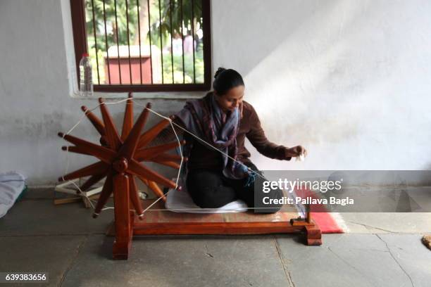 January 10. A volunteer deftly spins cotton yarn in the home of the Mahatma. The unusually sparse home of the Mahatma Gandhi, called the Father of...