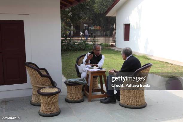 January 10. Scholars deep in conversation about Gandhi's philosophy at the ashram. The unusually sparse home of the Mahatma Gandhi, called the Father...