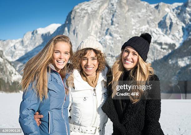 three beautiful women, candid winter portrait - close up of beautiful young blonde woman with black hat stock pictures, royalty-free photos & images