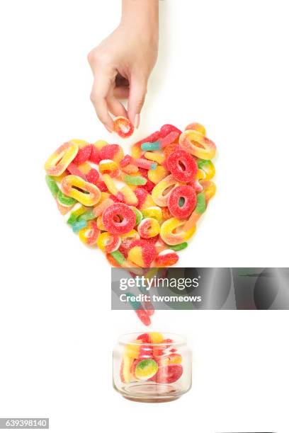 heart shaped gummy candy still life. - candy jar stock pictures, royalty-free photos & images