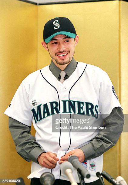 Ichiro Suzuki celebrates joining the MLB and signing a three-year contract with the Seattle Mariners in his uniform during the press conference on...