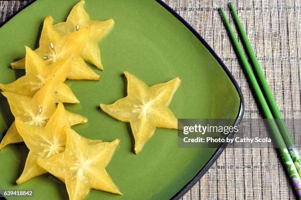 star fruit on plate - carambola stock pictures, royalty-free photos & images