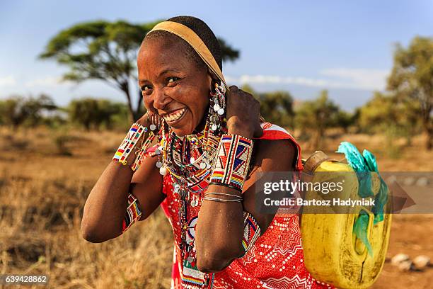 african woman from maasai tribe carrying water, kenya, east africa - carrying water stock pictures, royalty-free photos & images