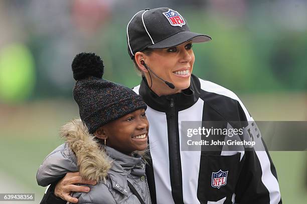 Referee Sarah Thomas meets a young fan before the game between the Philadelphia Eagles and the Cincinnati Bengals at Paul Brown Stadium on December...