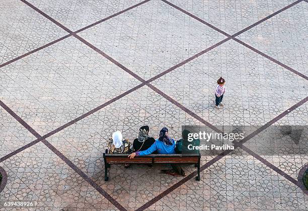 muslim womens sitting, girl playing ,chefchaouen,morocco,north africa - moroccan girls stock pictures, royalty-free photos & images