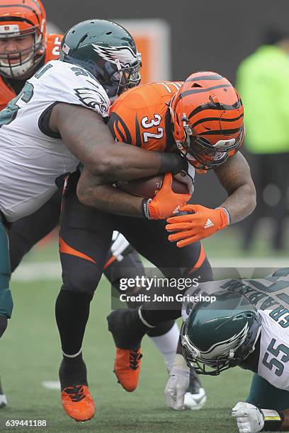 Jeremy Hill of the Cincinnati Bengals runs the football upfield against Bennie Logan of the Philadelphia Eagles during their game at Paul Brown...