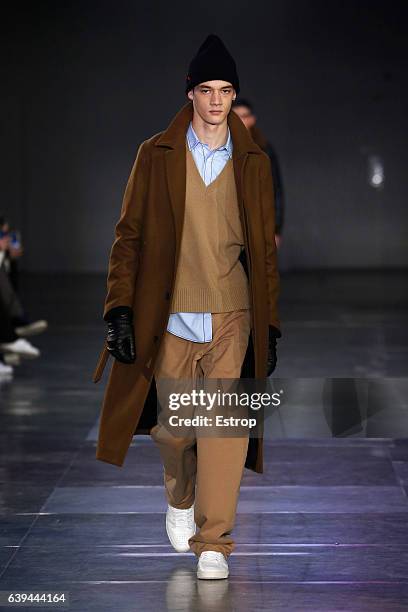 Model walks the runway during the Ami Alexandre Mattiussi Menswear Fall/Winter 2017-2018 show as part of Paris Fashion Week on January 21, 2017 in...