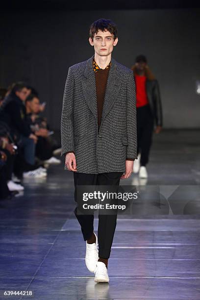 Model walks the runway during the Ami Alexandre Mattiussi Menswear Fall/Winter 2017-2018 show as part of Paris Fashion Week on January 21, 2017 in...