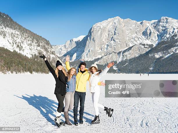 friends having fun on frozen lake altaussee, winter wonderland - close up of beautiful young blonde woman with black hat stock pictures, royalty-free photos & images