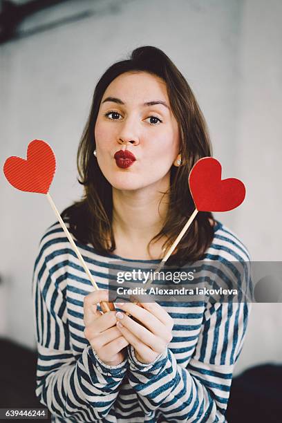 beautiful young woman holding paper hearts - iakovleva stock pictures, royalty-free photos & images