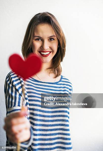 beautiful young woman holding paper heart - alexandra iakovleva stock pictures, royalty-free photos & images