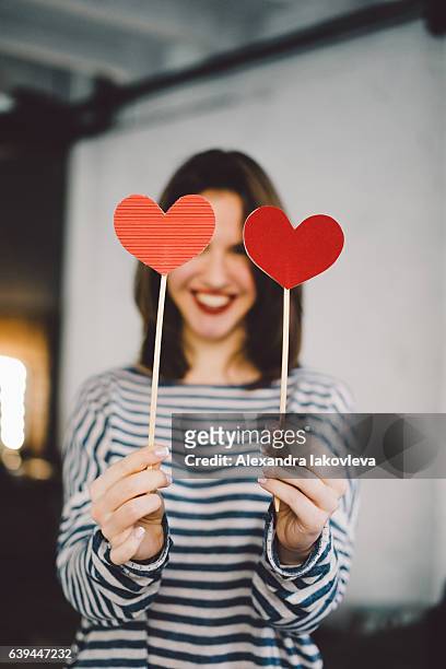 beautiful young woman holding paper hearts - iakovleva stock pictures, royalty-free photos & images