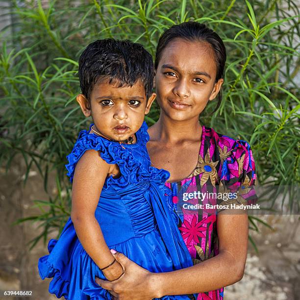 indian young girl holding her young sister, jaipur, india - rajasthani youth stock pictures, royalty-free photos & images