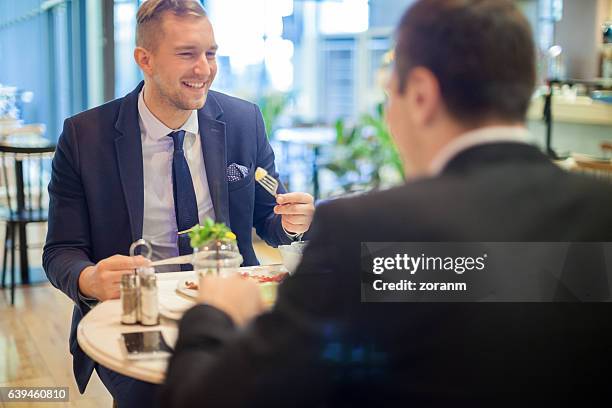 business colleagues in canteen having lunch - colleague lunch stock pictures, royalty-free photos & images