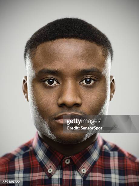 close-up portrait of serious man - black man plaid shirt stock pictures, royalty-free photos & images