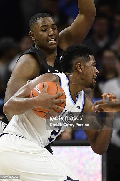 Kalif Young of the Providence Friars guards Kris Jenkins of the Villanova Wildcats during the first half at the Wells Fargo Center on January 21,...