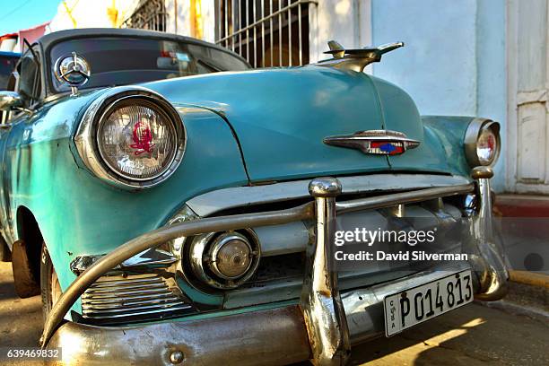 S model Chevrolet is decorated with Che Guevara decals on its headlights on December 25, 2015 in Trinidad, Cuba. As many as 60,000 American vehicles...