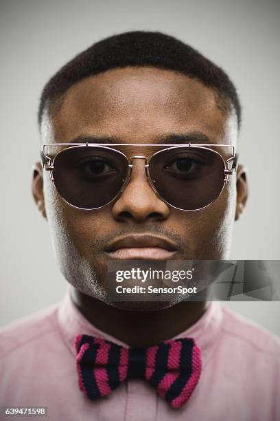 portrait of serious man in sunglasses and bow tie - nigeria fashion stock pictures, royalty-free photos & images