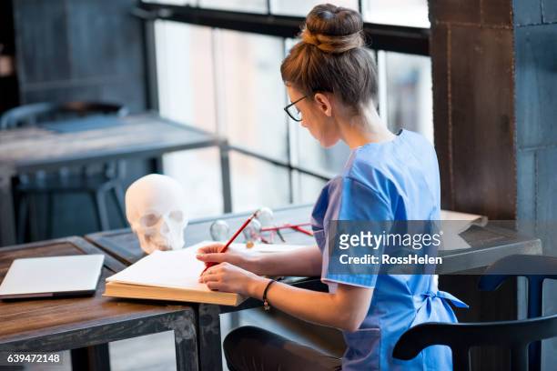 student working on medical exam - medicinsk procedur bildbanksfoton och bilder