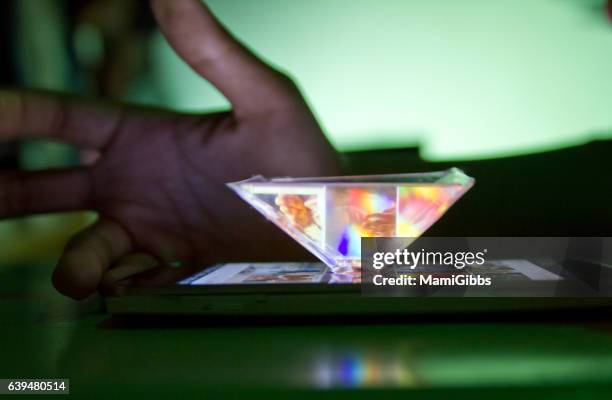 smartphone into a 3d hologram - smartphone hologram stock pictures, royalty-free photos & images