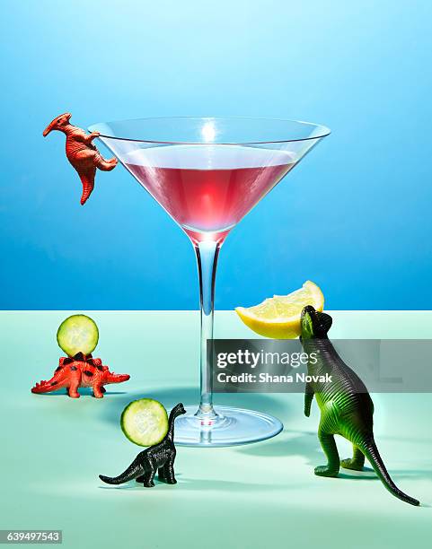 toy dinosaurs preparing a cocktail - glass figurine stock pictures, royalty-free photos & images