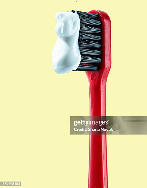 red toothbrush with paste - toothpaste stock pictures, royalty-free photos & images