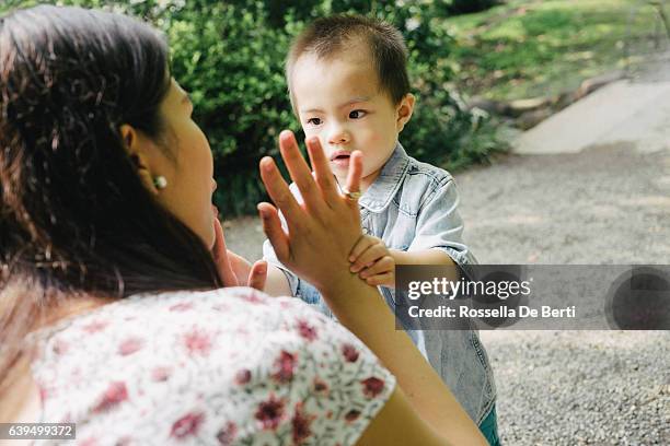 mother scolding her son outdoors in a park - pants down bildbanksfoton och bilder