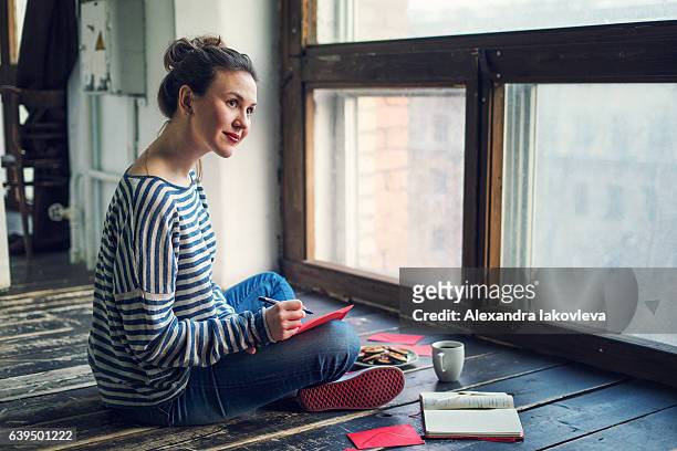 young woman writing a valentine card - love letter stock pictures, royalty-free photos & images