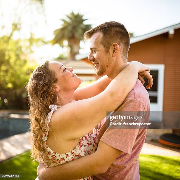 lovely couple flirting at sunset and dancing - big hug stock pictures, royalty-free photos & images