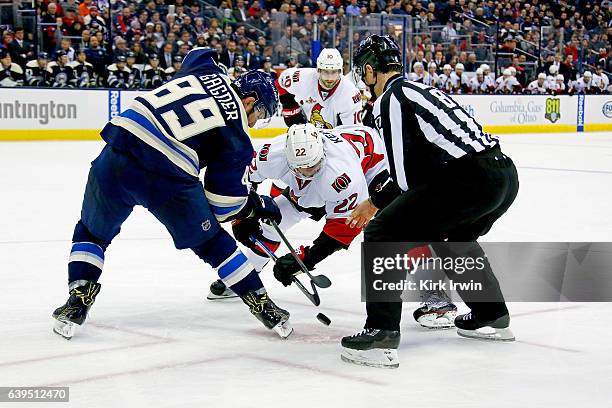 Linesman Devin Berg drops the puck for Sam Gagner of the Columbus Blue Jackets and Chris Kelly of the Ottawa Senators during the game on January 19,...