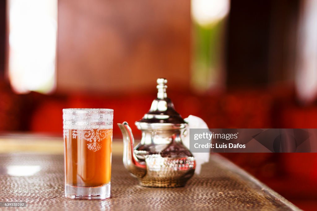 Teapot and glass on mint tea