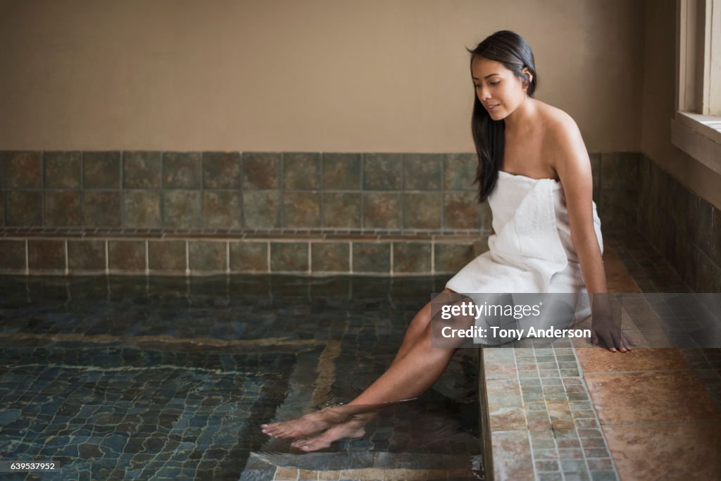 Young Native American woman wrapped in towel in hot tub