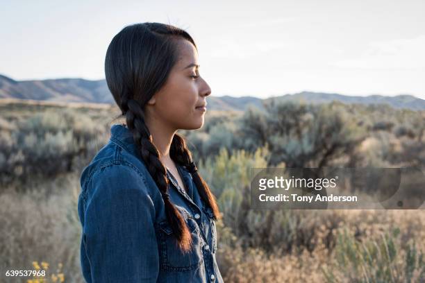 young native american woman outdoors at sunset - aboriginal woman stock-fotos und bilder