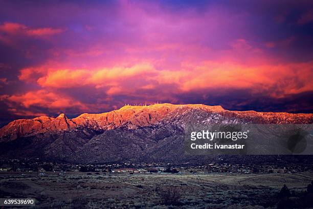 snow dusted sandia mountains at magic hour - romantic sky stock pictures, royalty-free photos & images