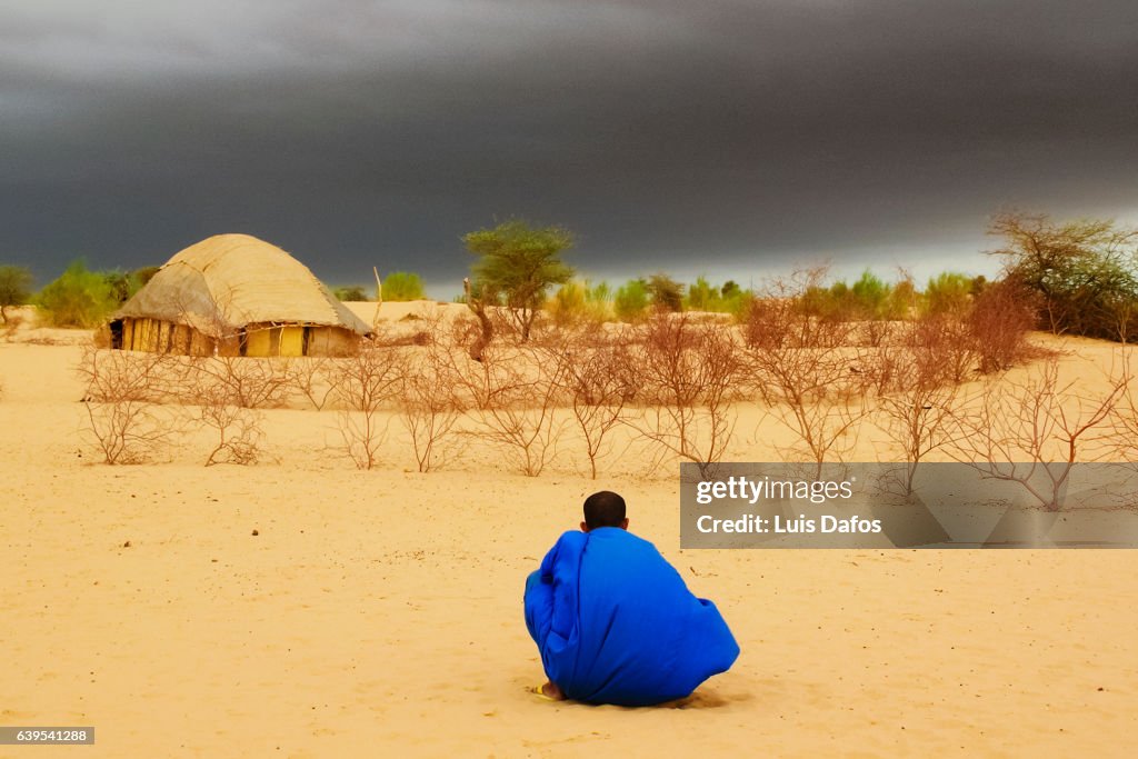 Tuareg stalking at dark clouds
