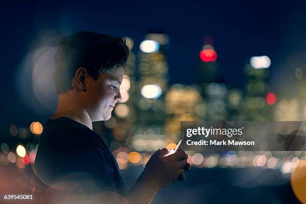 teenagers on iphones - person looking at phone while smiling australia stock pictures, royalty-free photos & images