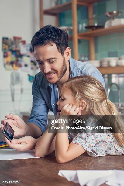 father and daughter spending time at home together - famiglia multimediale foto e immagini stock