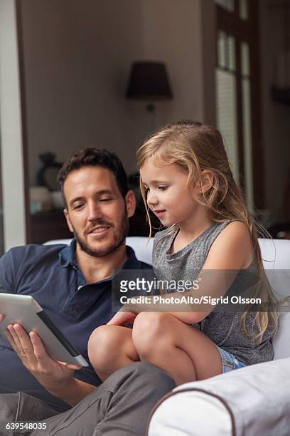 father and daughter using digital tablet together - easy solutions fotografías e imágenes de stock