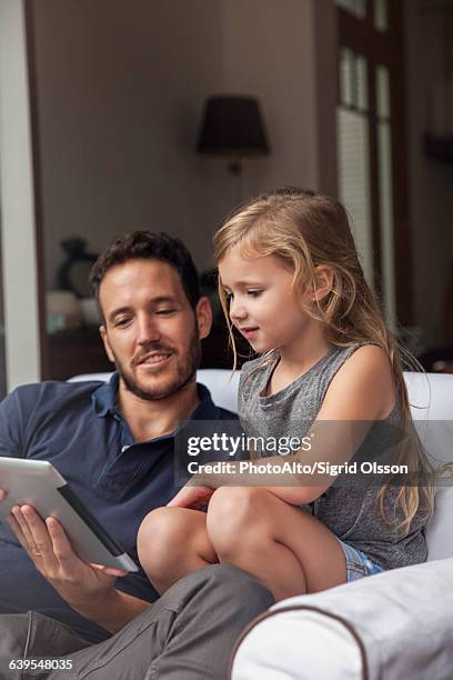 father and daughter using digital tablet together - easy solutions stock pictures, royalty-free photos & images