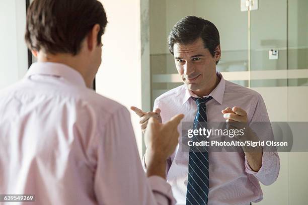 man smiling at his reflection in mirror - ego perspektive stock-fotos und bilder